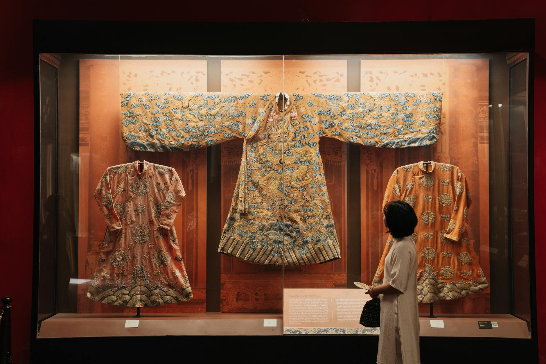 Visitor exploring Munich museum exhibit with cultural art display