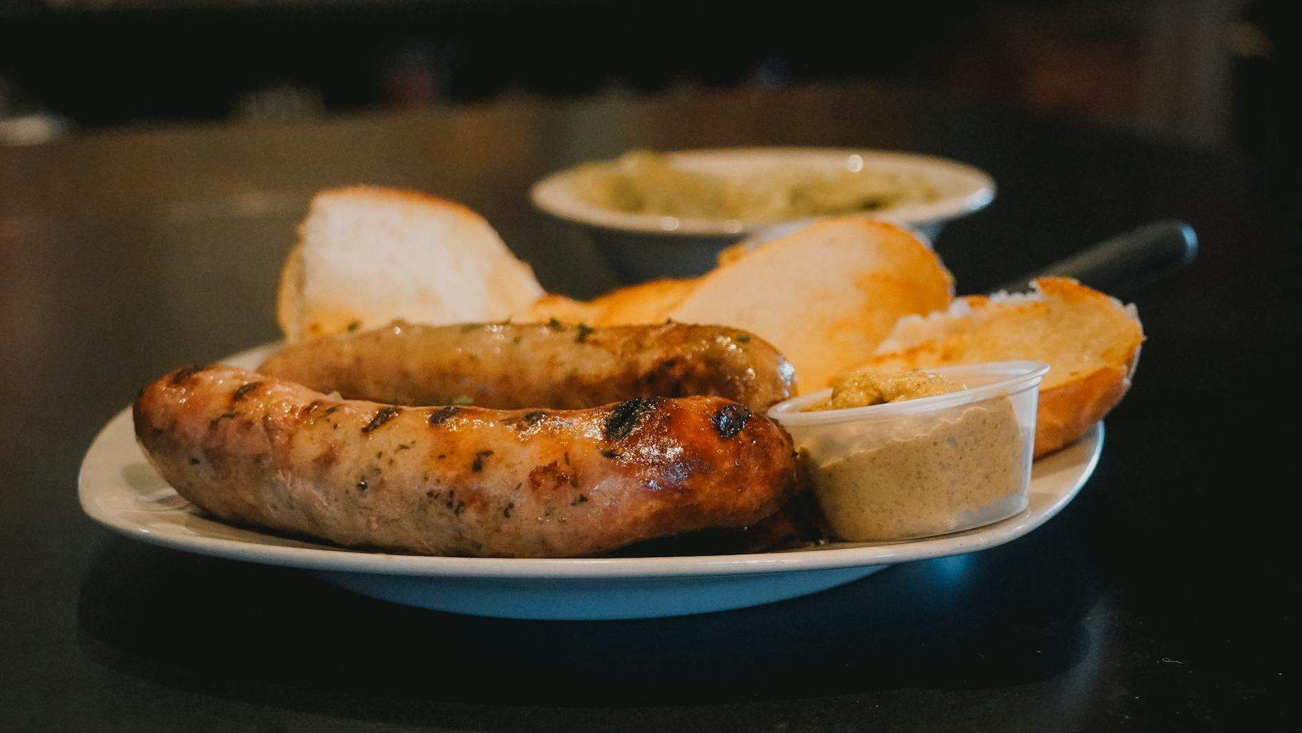 Munich Weisswurst traditional Bavarian white sausage with sweet mustard and pretzel