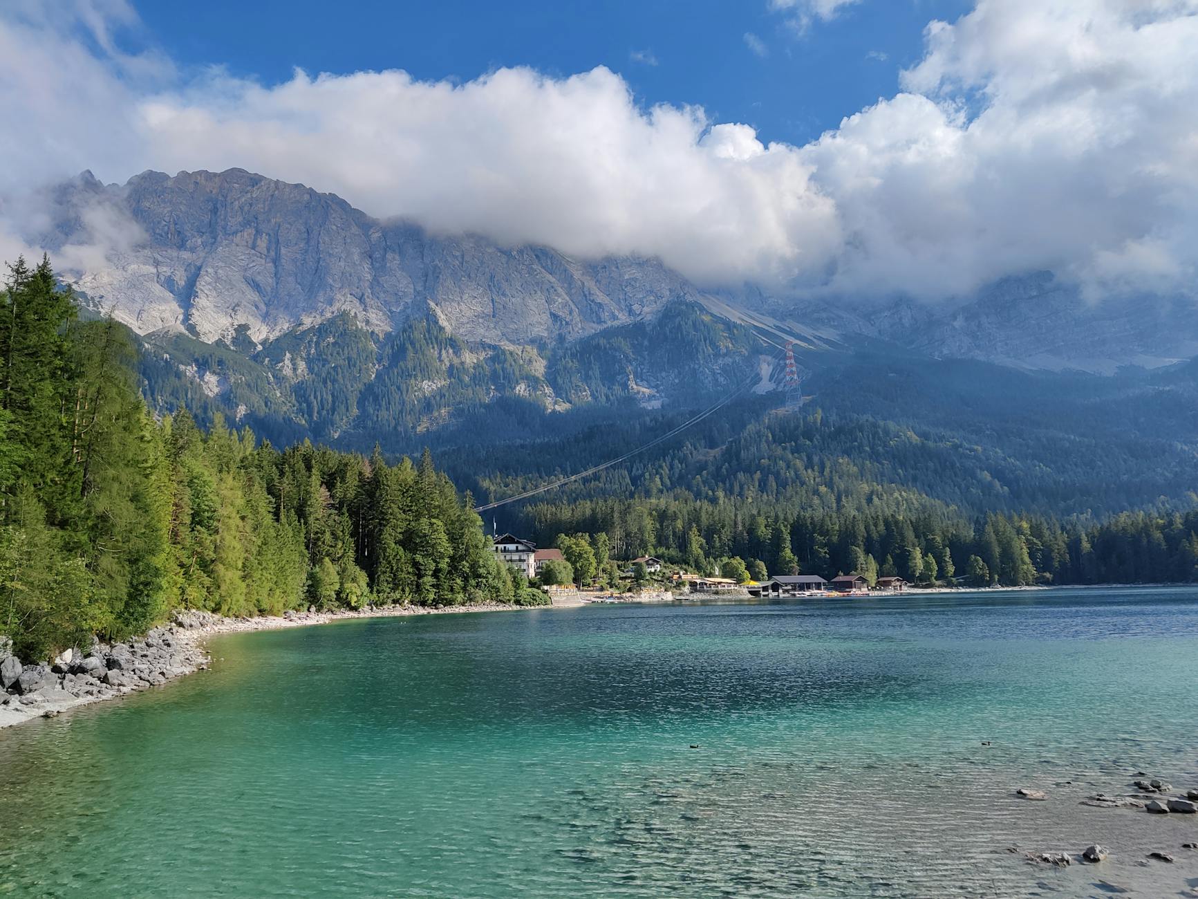 Lakes near Munich turquoise Eibsee beneath Zugspitze peak with wooden rowboat
