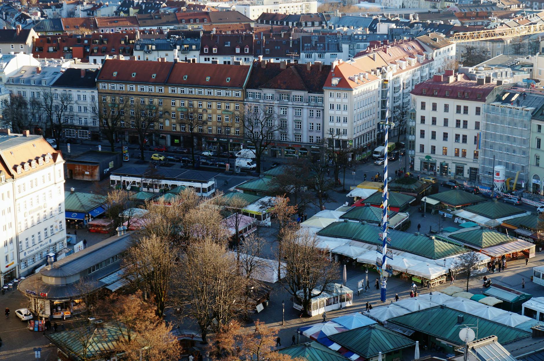 Viktualienmarkt Munich blue and white maypole rising above food stalls fruit flowers Altstadt