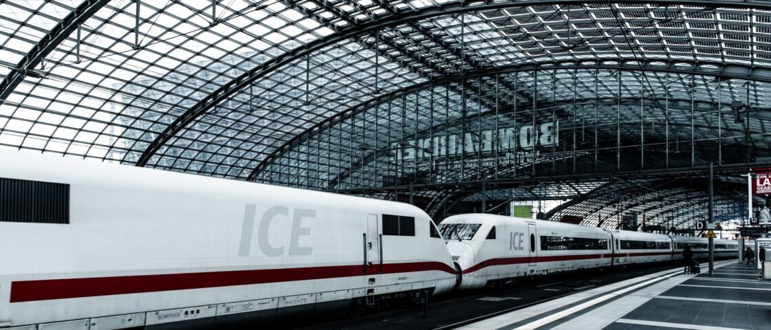 Two ICE trains waiting under the glass barrel roof of Berlin Hauptbahnhof