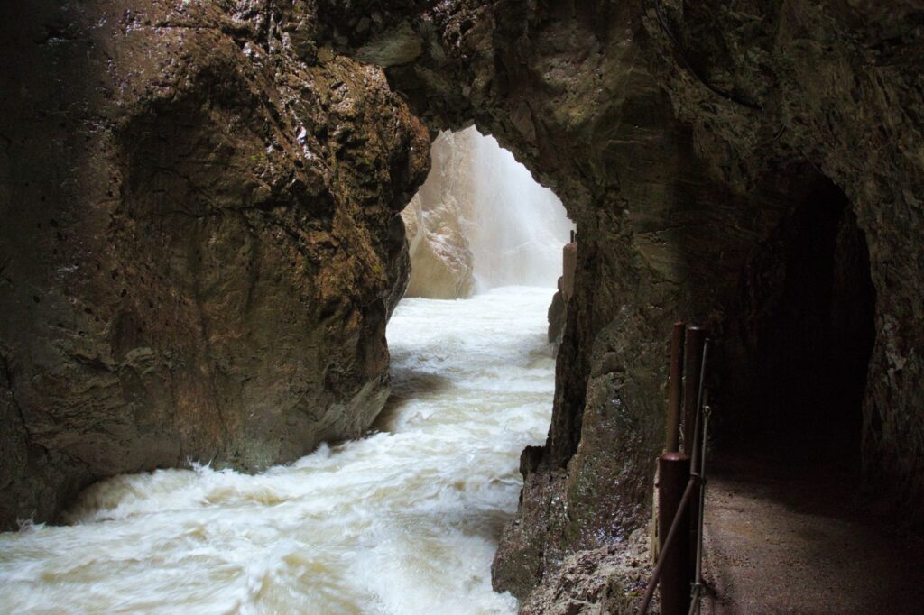 Best Day Hikes Near Munich (Reachable by Train) 2 Rock-cut walkway with a handrail beside the torrent inside the Partnachklamm gorge