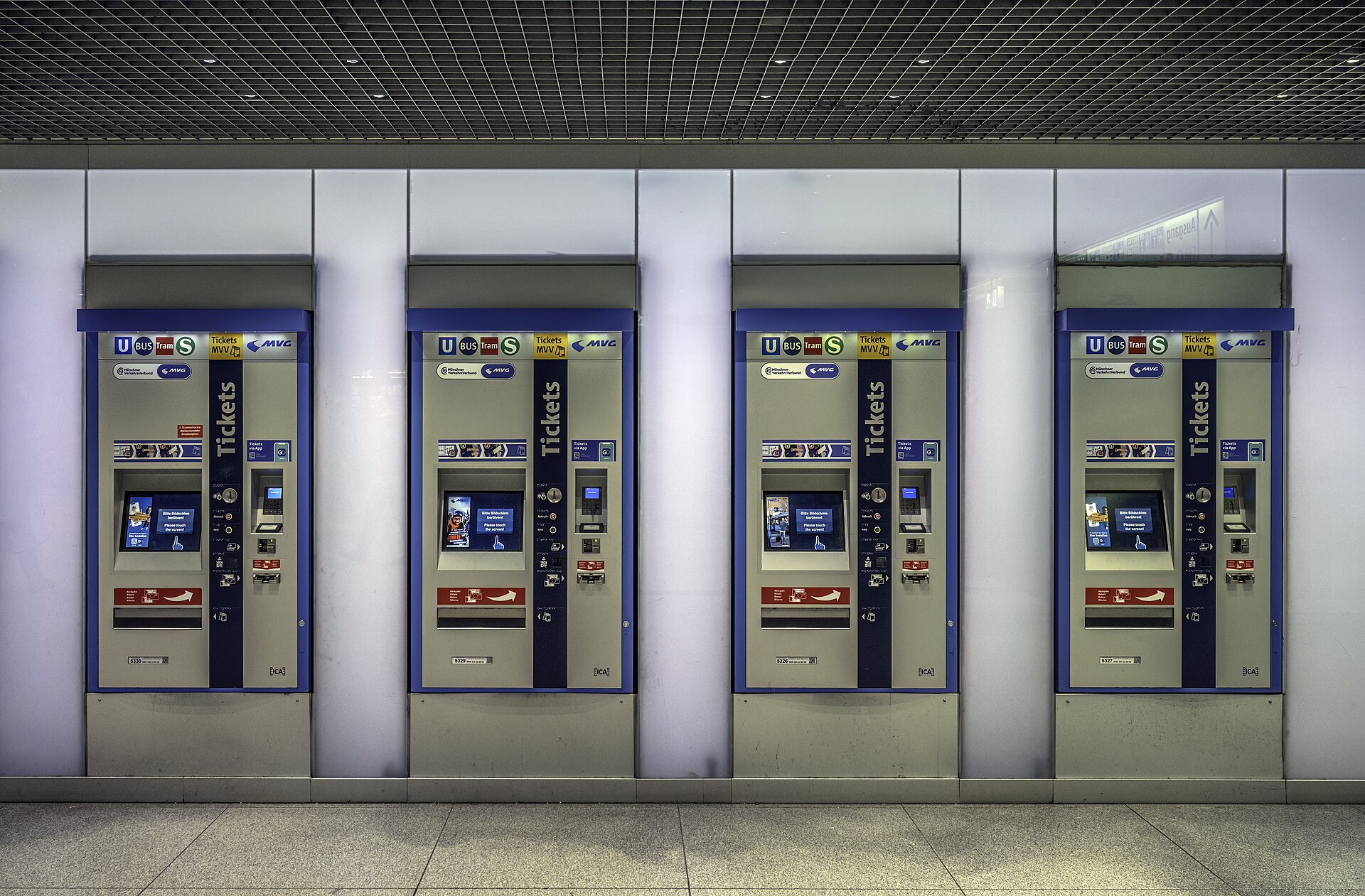 Getting Around Munich: Complete Transport Guide 4 Four MVG ticket machines in a Munich station have touchscreens, payment controls and ticket collection slots.