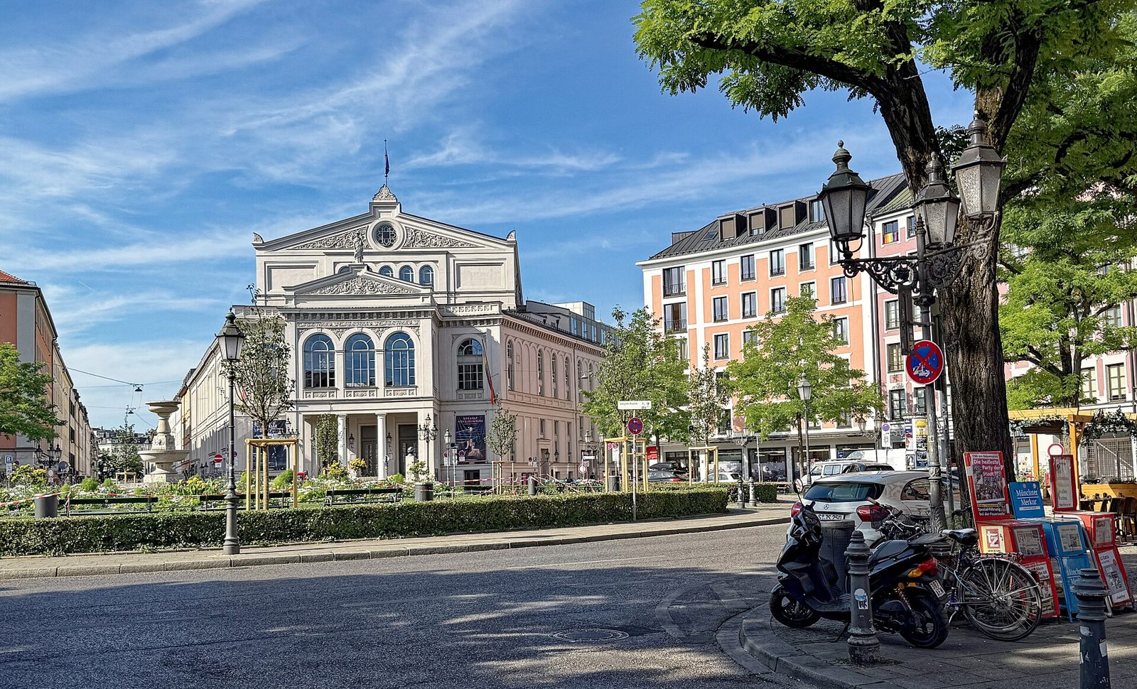 Munich Pride (CSD): Dates, Route and What to Expect 2 The Gärtnerplatz with the classical façade of the Staatstheater am Gärtnerplatz behind trees and a lamp post