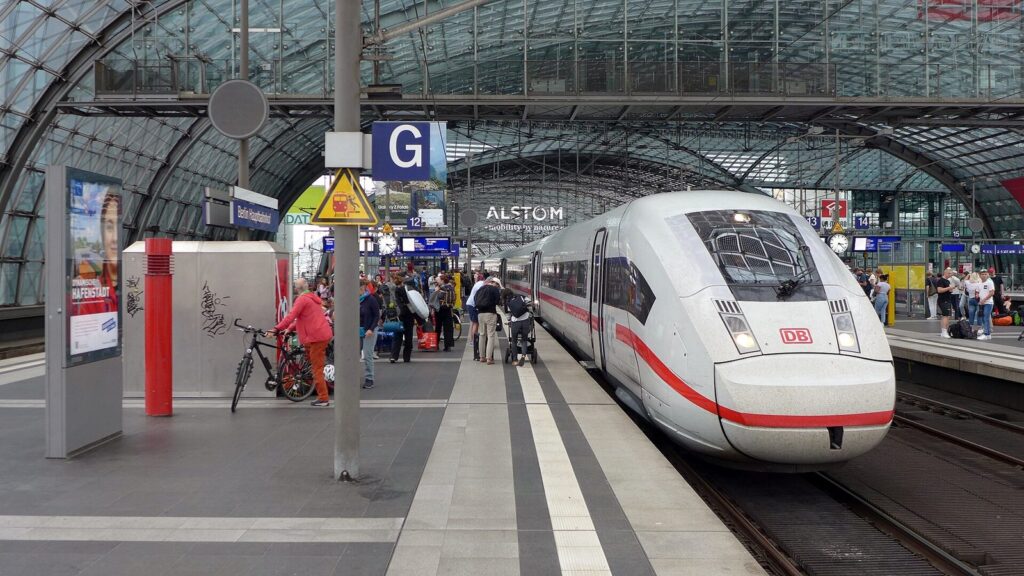 Munich to Berlin: Train vs Flight vs Bus 1 A white ICE train at a platform under the glass roof of Berlin Hauptbahnhof