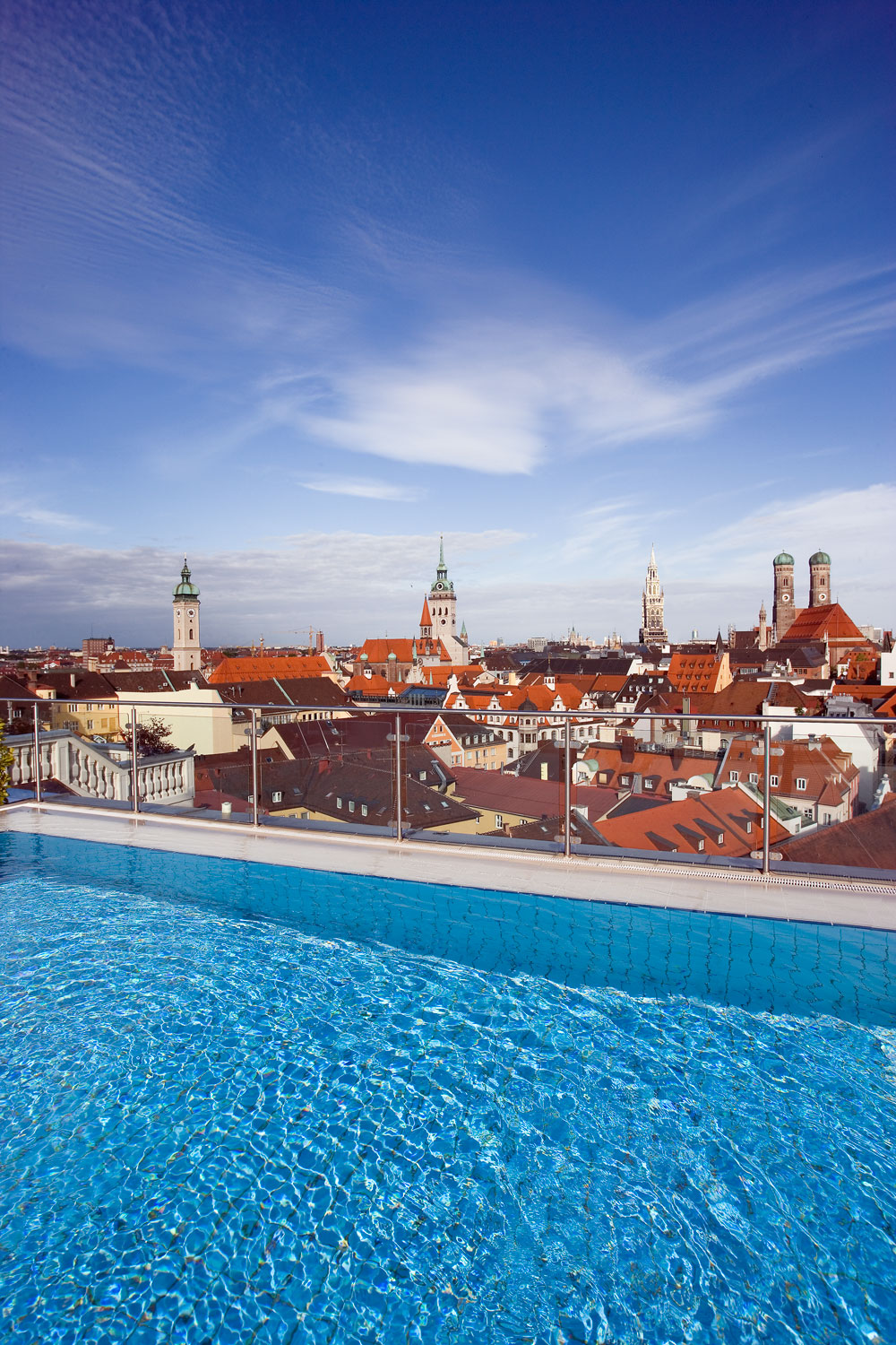 The Mandarin Oriental rooftop pool overlooks Munich’s red rooftops, church towers and the twin domes of the Frauenkirche.