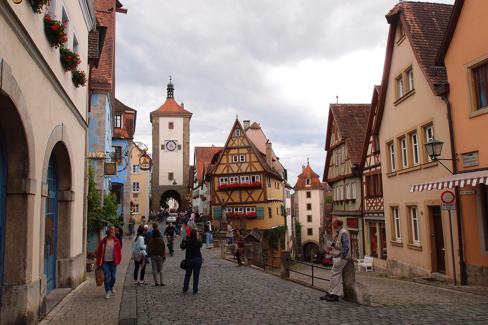 Rothenburg ob der Tauber from Munich: Complete Day Trip Guide 3 Visitors walk along Rothenburg’s cobbled Plönlein, where half-timbered houses stand between two gate towers.